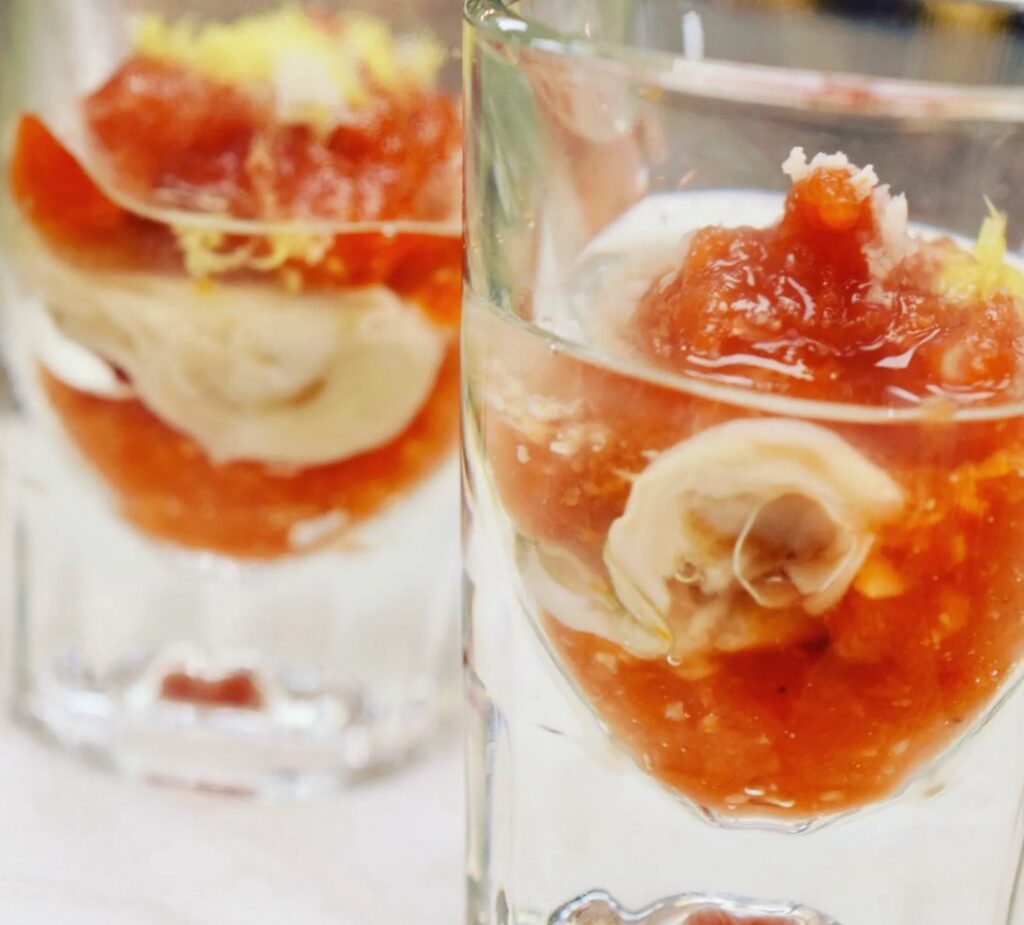 Individual seafood and tomato appetizers served in chilled glasses with citrus zest at Blueprint on 3rd