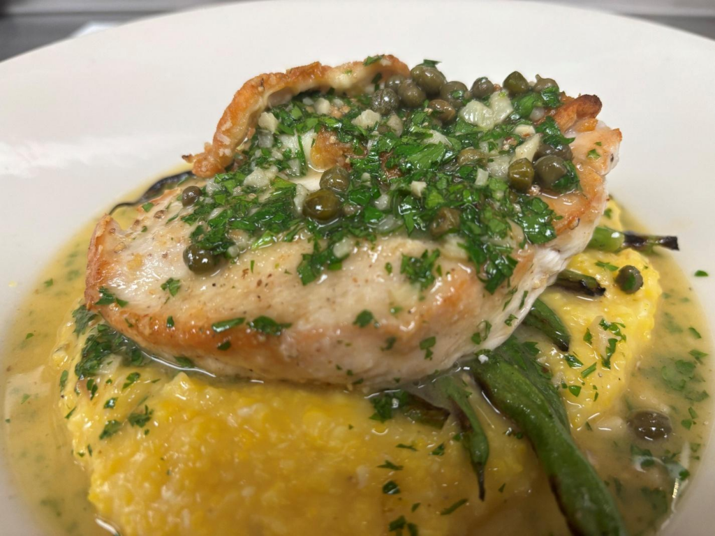Pan-seared chicken with capers and parsley over polenta and green beans at Blueprint on 3rd in Birmingham